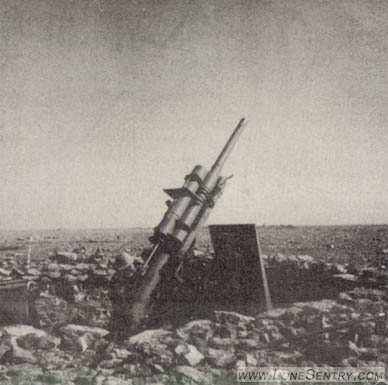 [This photograph shows a type of armor shield used in some Axis gun emplacements, and also the rocky soil that is characteristic of the Libyan Plateau. The gun is not identified.]